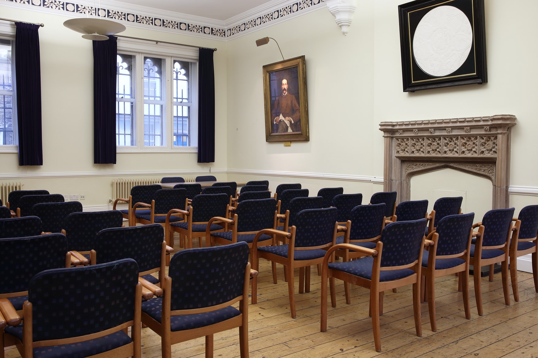 Lecture Room 6 - an auditorium set up with portraits hanging on white walls