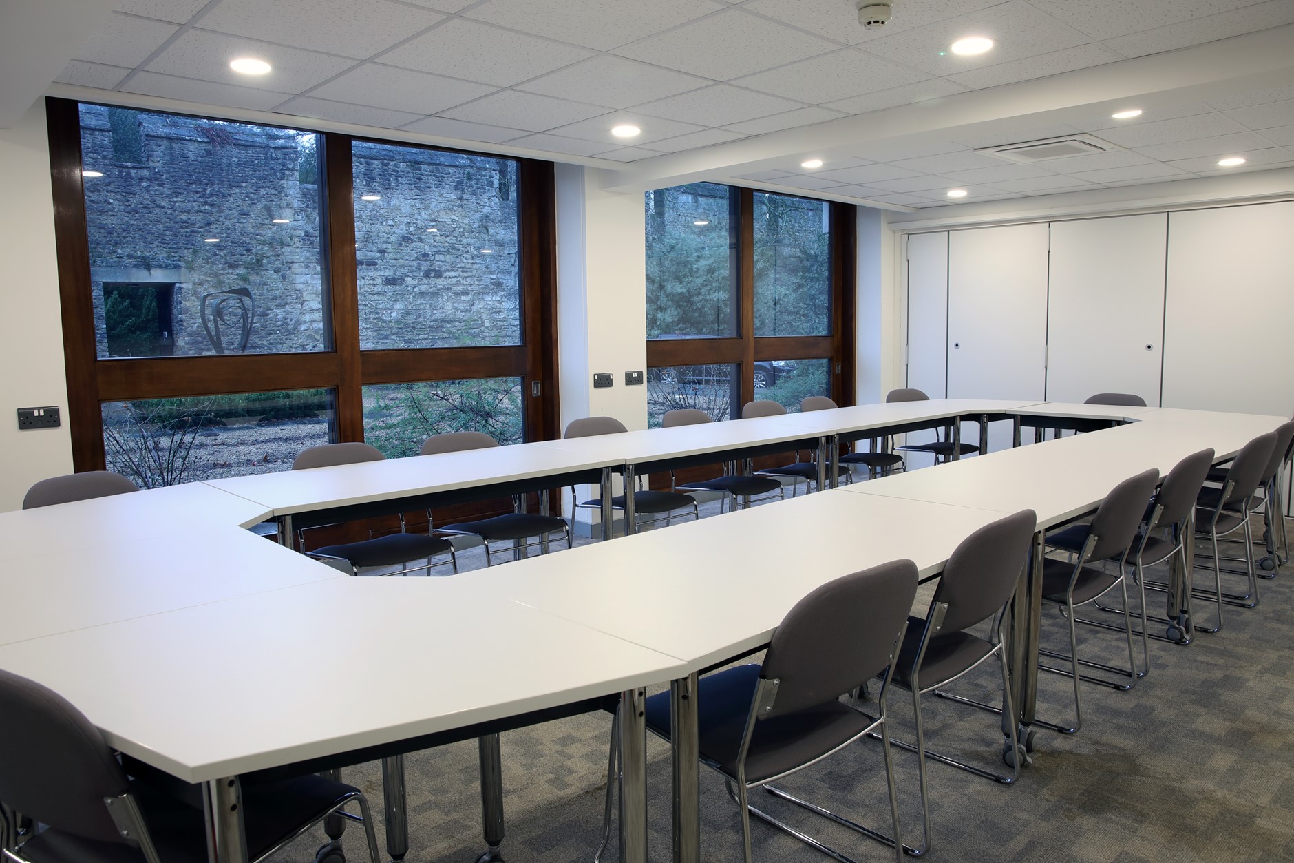 Spooner Room 1 - a boardroom meeting room with a view of the Oxford city wall